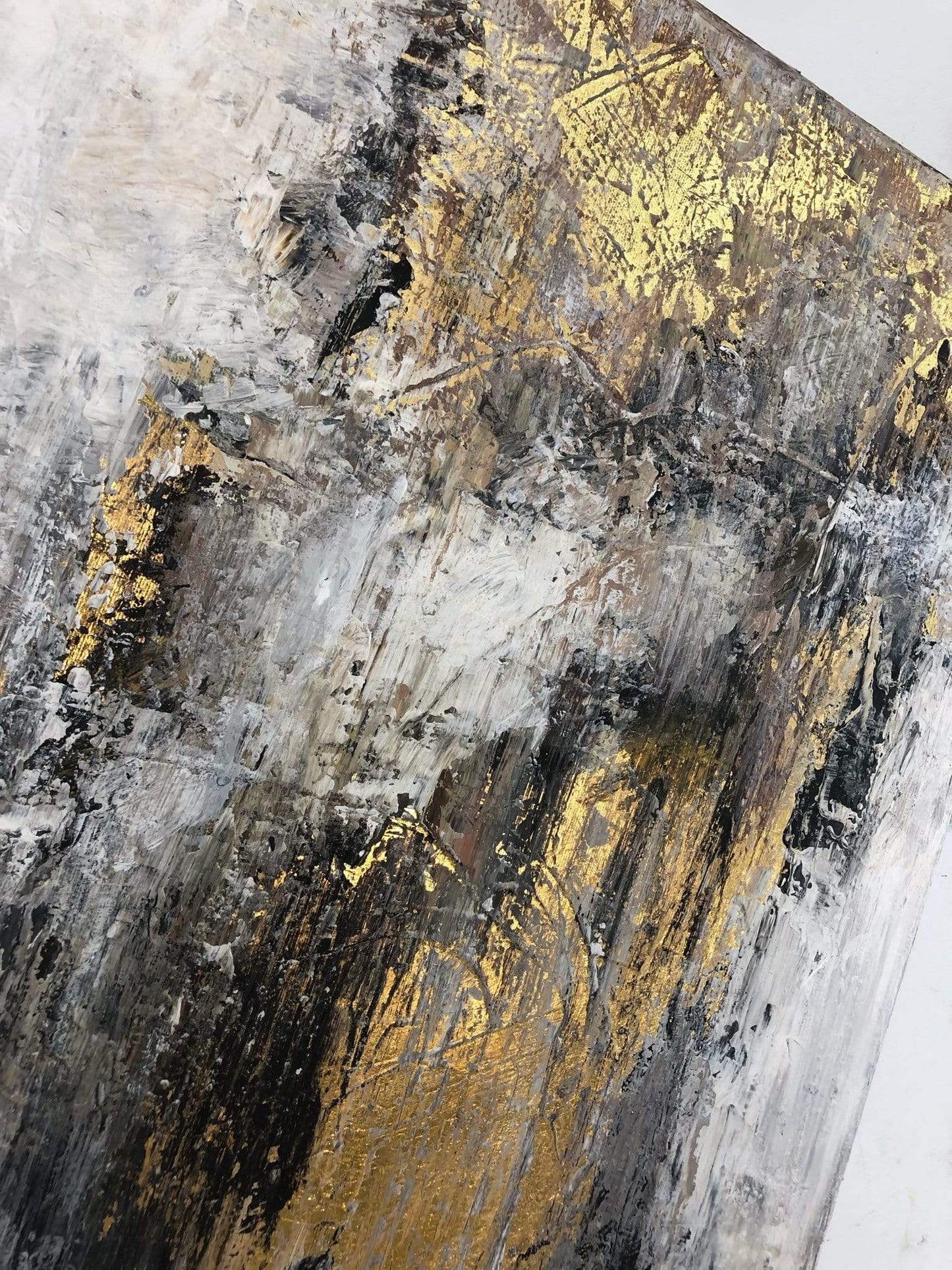 an abstract painting with gold and black colors