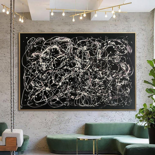 a large abstract painting hanging on a wall, with a green couch and a potted plant in the foreground.