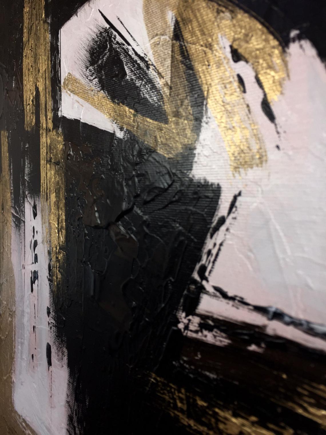 a close up of a black and gold painting