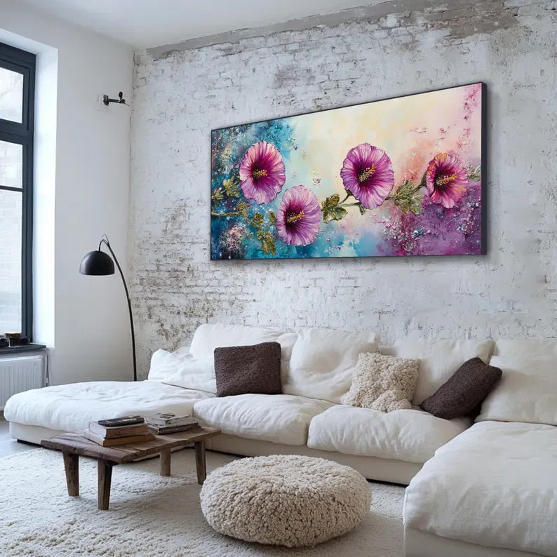 a cozy living room with a large, vibrant painting of pink flowers hanging on the wall above a white sectional sofa. The sofa is adorned with two brown throw pillows and a beige shag rug covers the floor. A wooden coffee table sits in front of the sofa, and a floor lamp stands nearby.