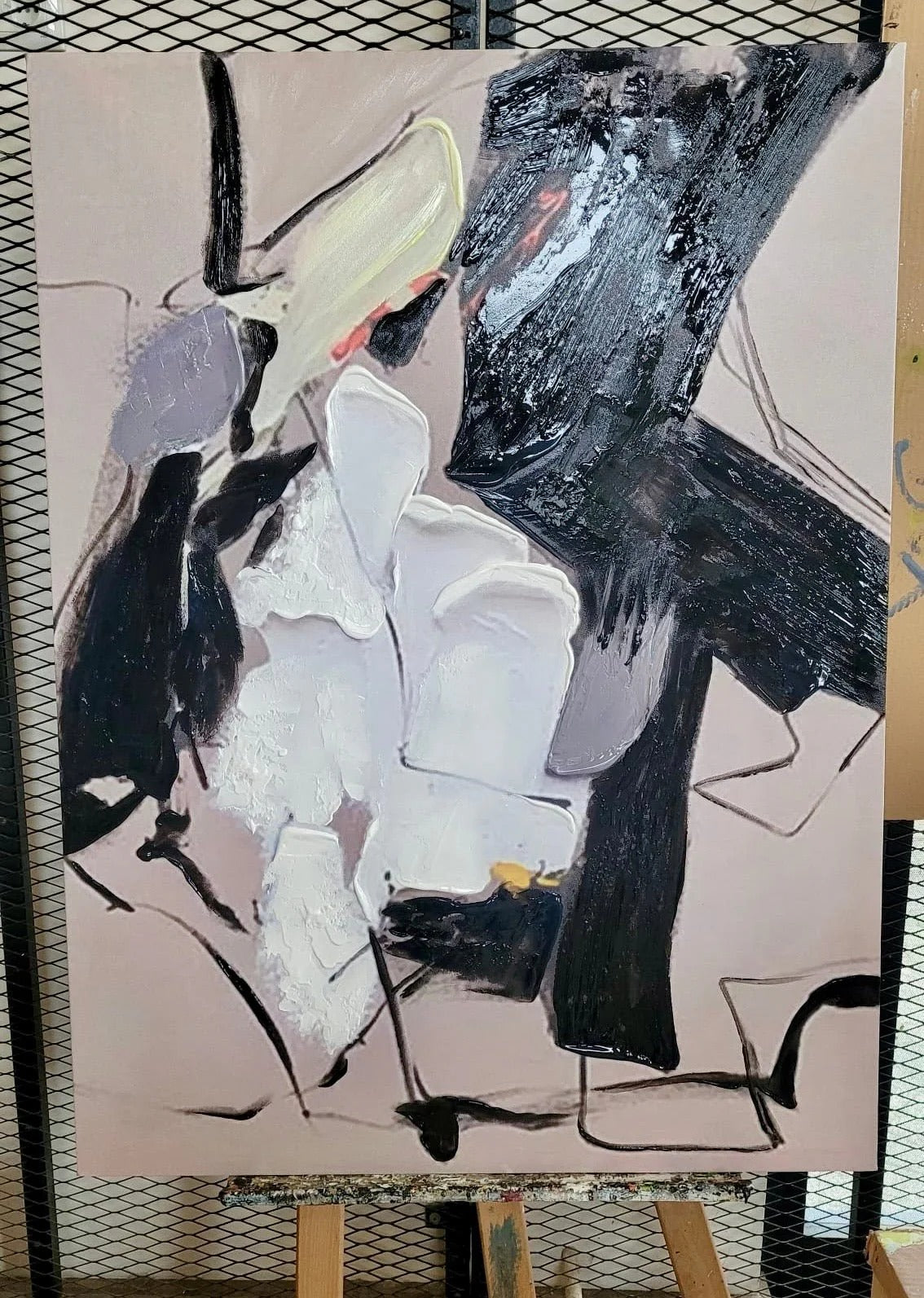 The image is an abstract painting with bold black and white colors, featuring a mix of shapes and textures.