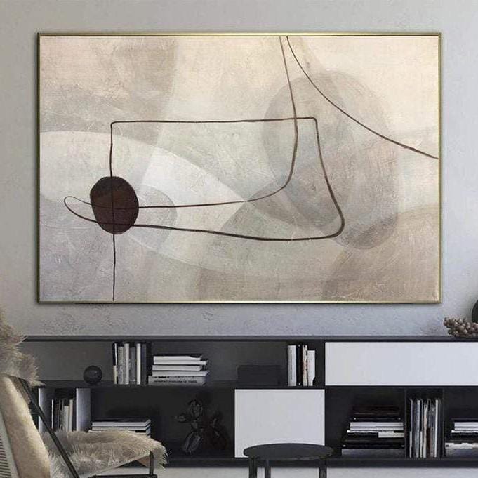 a large abstract painting hanging on a wall above a bookshelf filled with books.