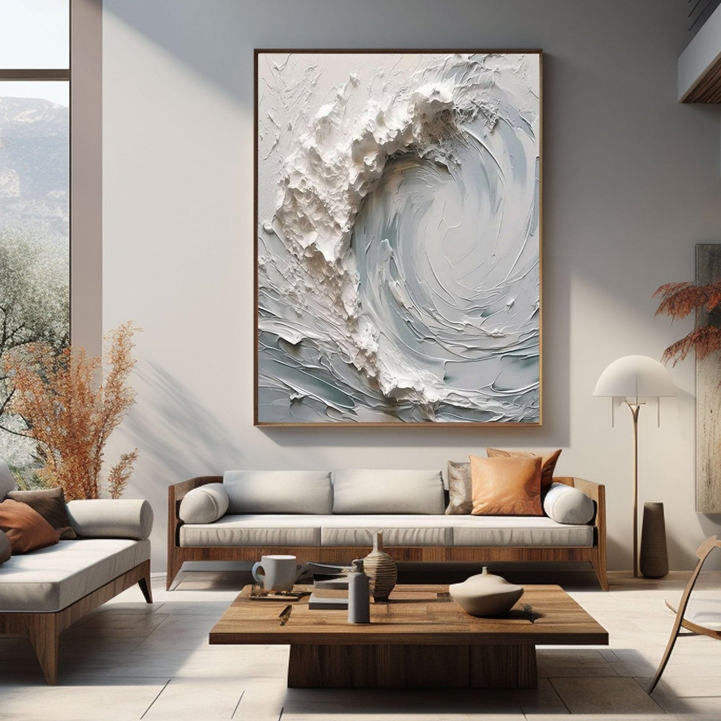 a modern living room with a large, abstract painting of a wave hanging on the wall above a white sofa. The room also includes a wooden coffee table, a wooden side table, and a large window overlooking a scenic outdoor view.