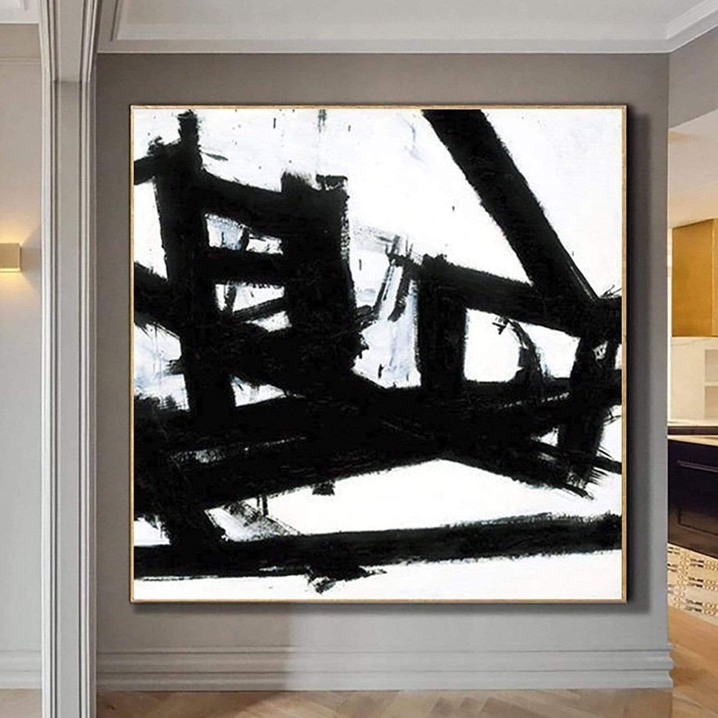 a black and white painting hanging on a wall