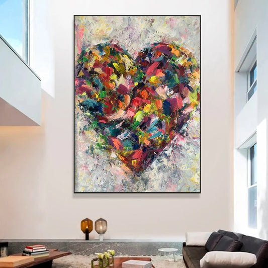 a large, colorful painting of a heart hanging on a wall in a modern living room.