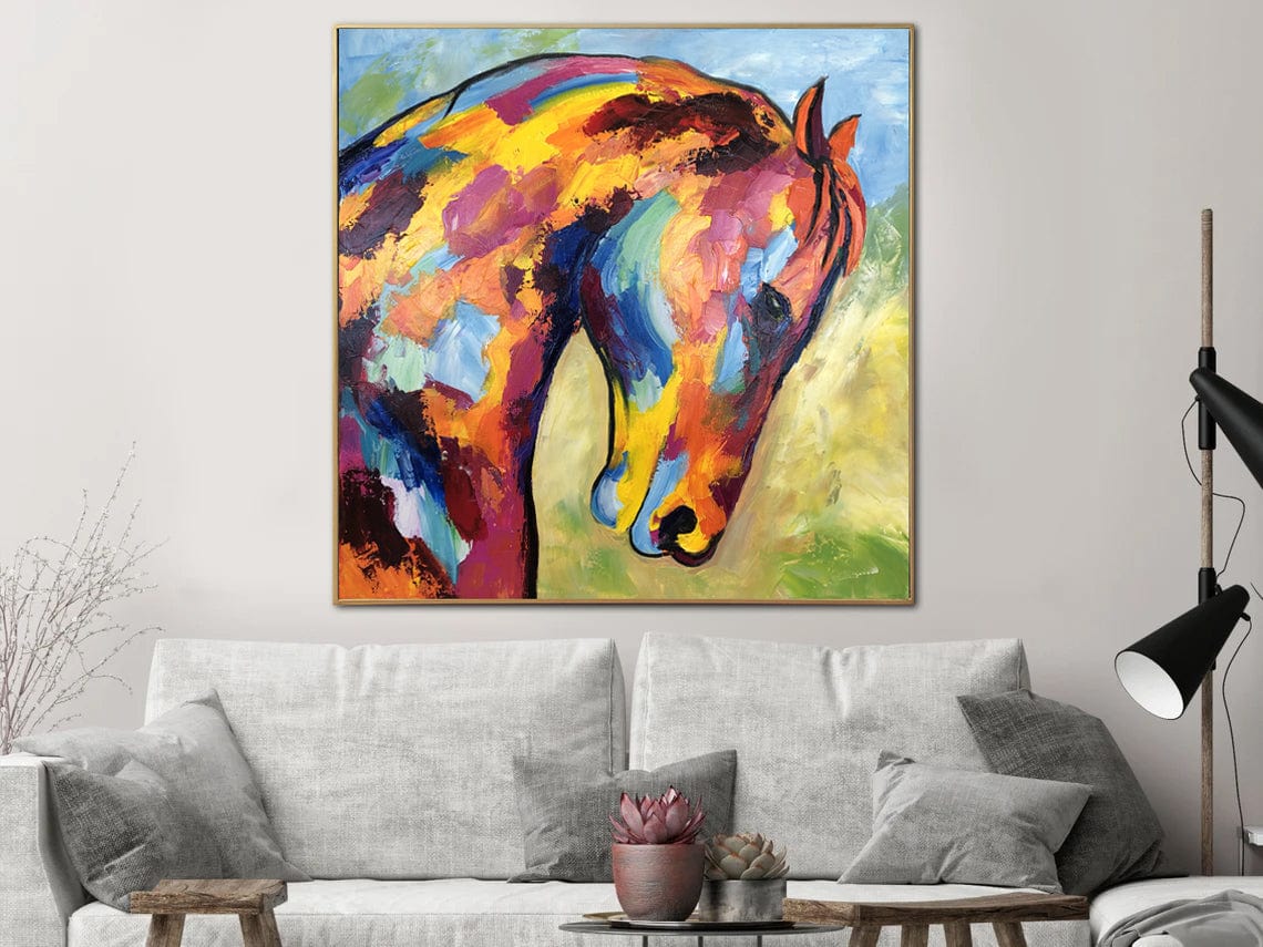 a painting of a horse on a wall above a couch