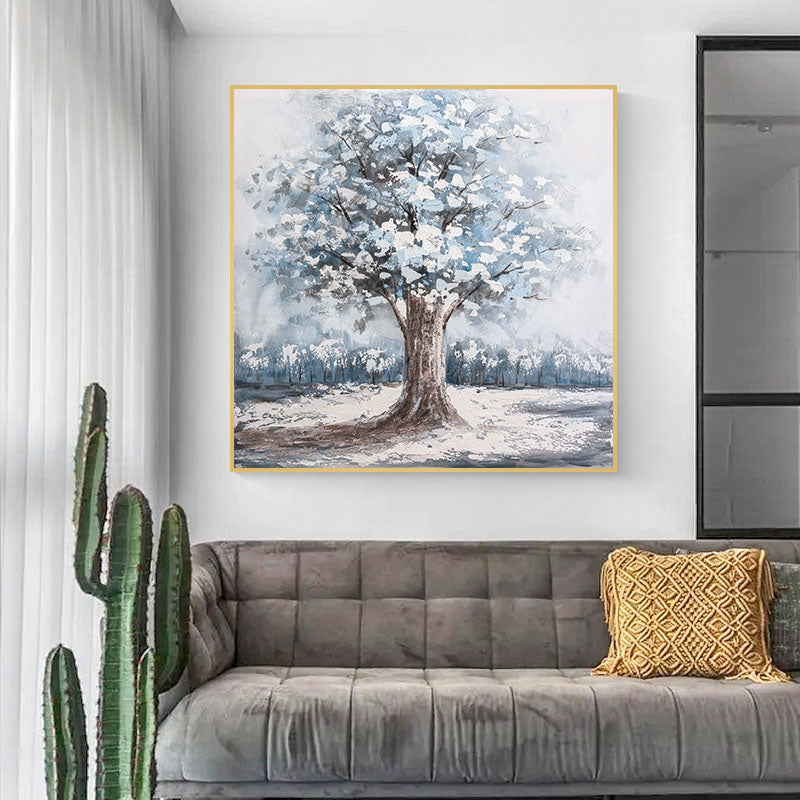 a living room with a couch and a painting on the wall