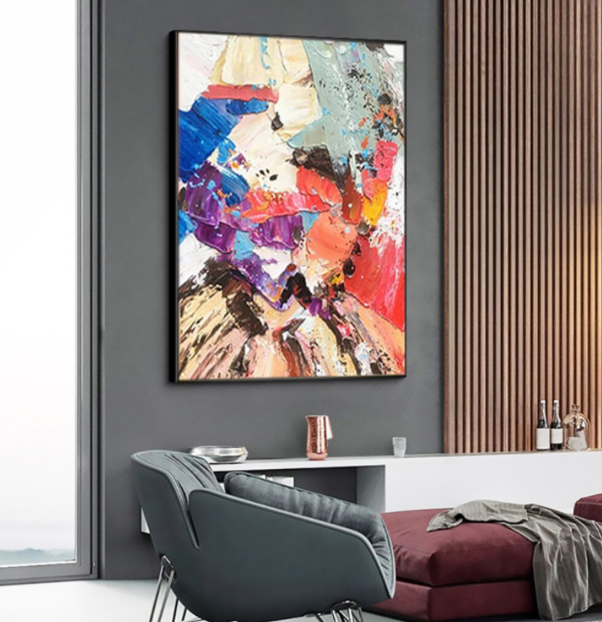 a living room with a large painting on the wall