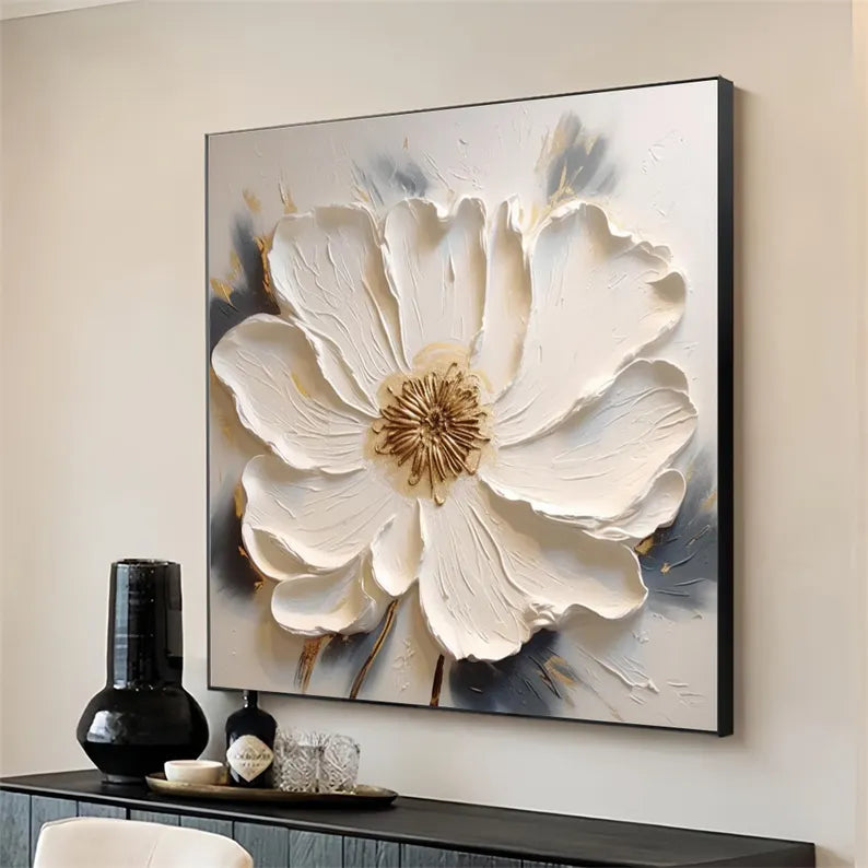 a large white flower is hanging on a wall