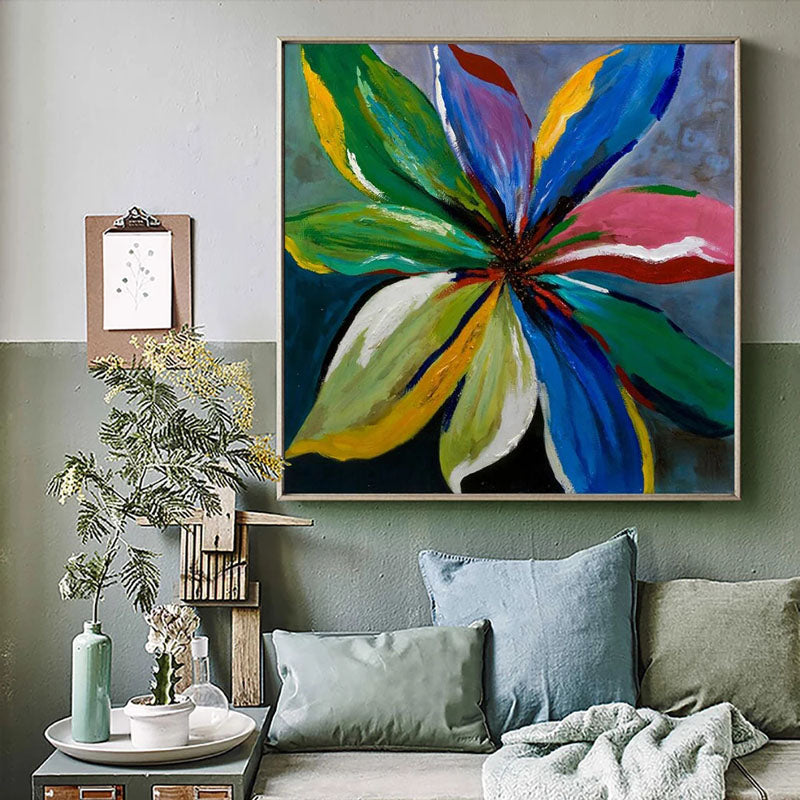 a living room with a couch and a painting on the wall