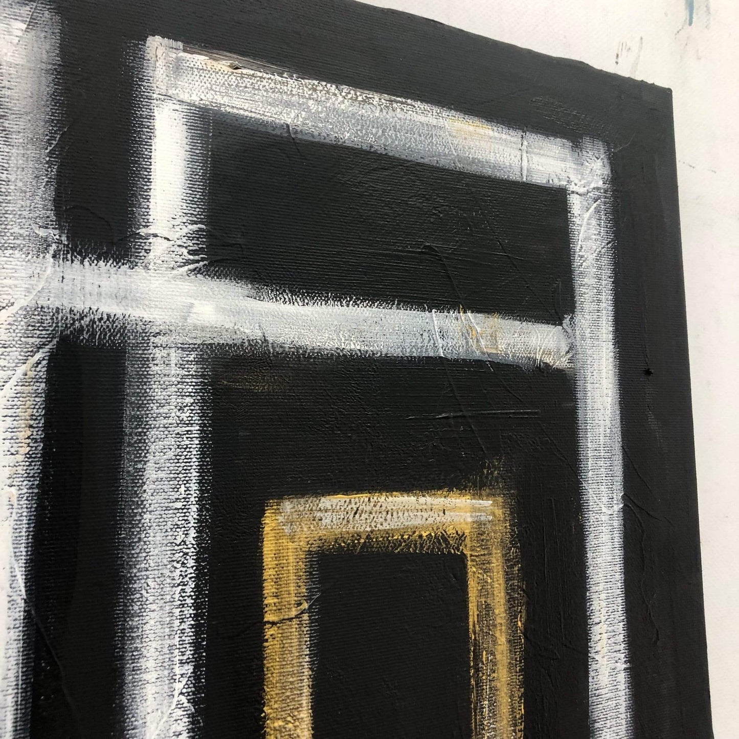 a black and white painting with a yellow square