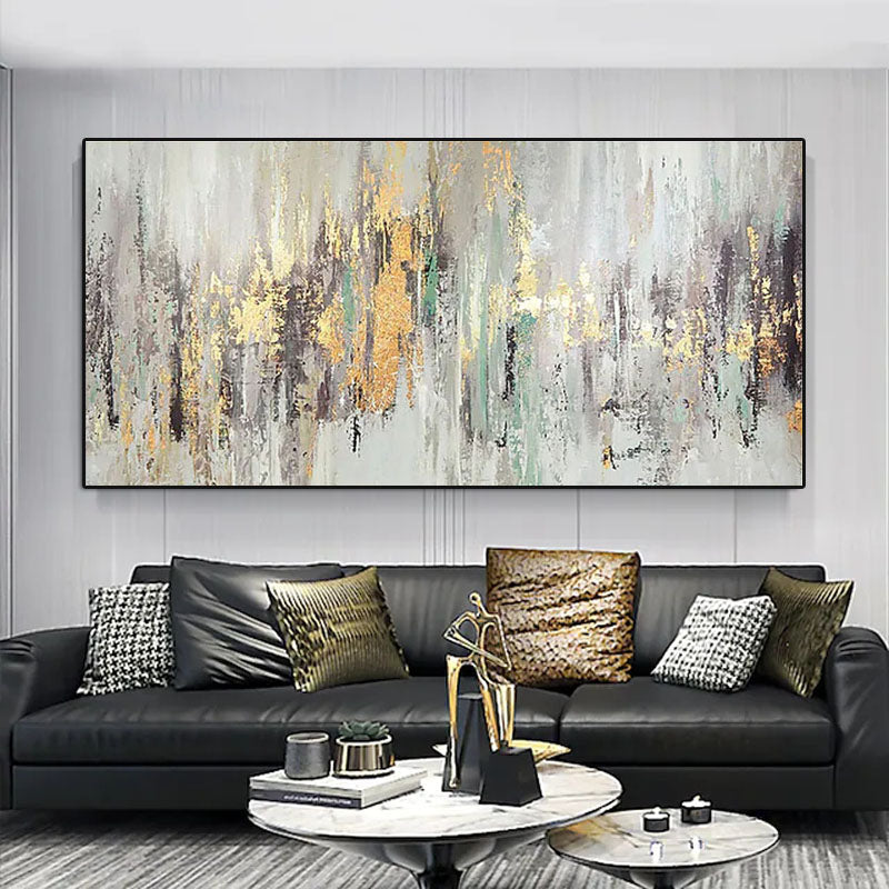 a living room with a black couch and a large painting on the wall