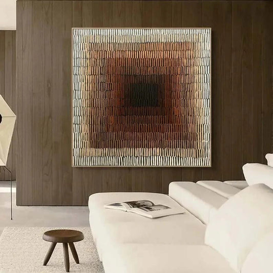 a modern living room with a large abstract painting on the wall, a white sofa, and a small wooden stool.