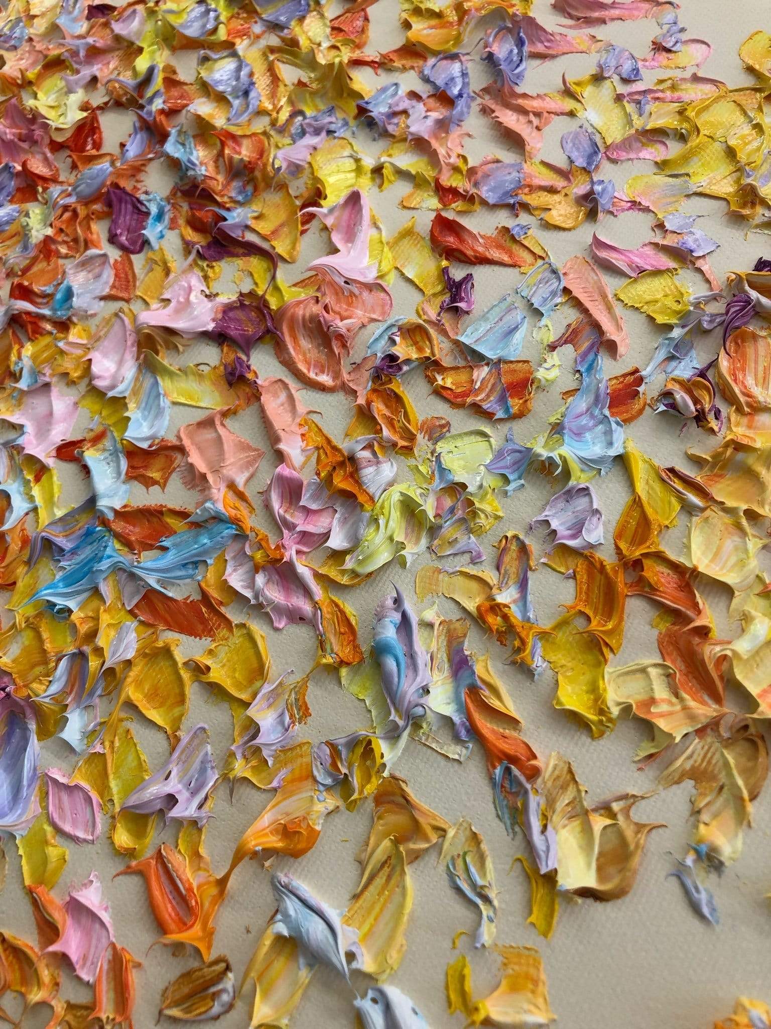 a pile of colorful paper flowers on a table