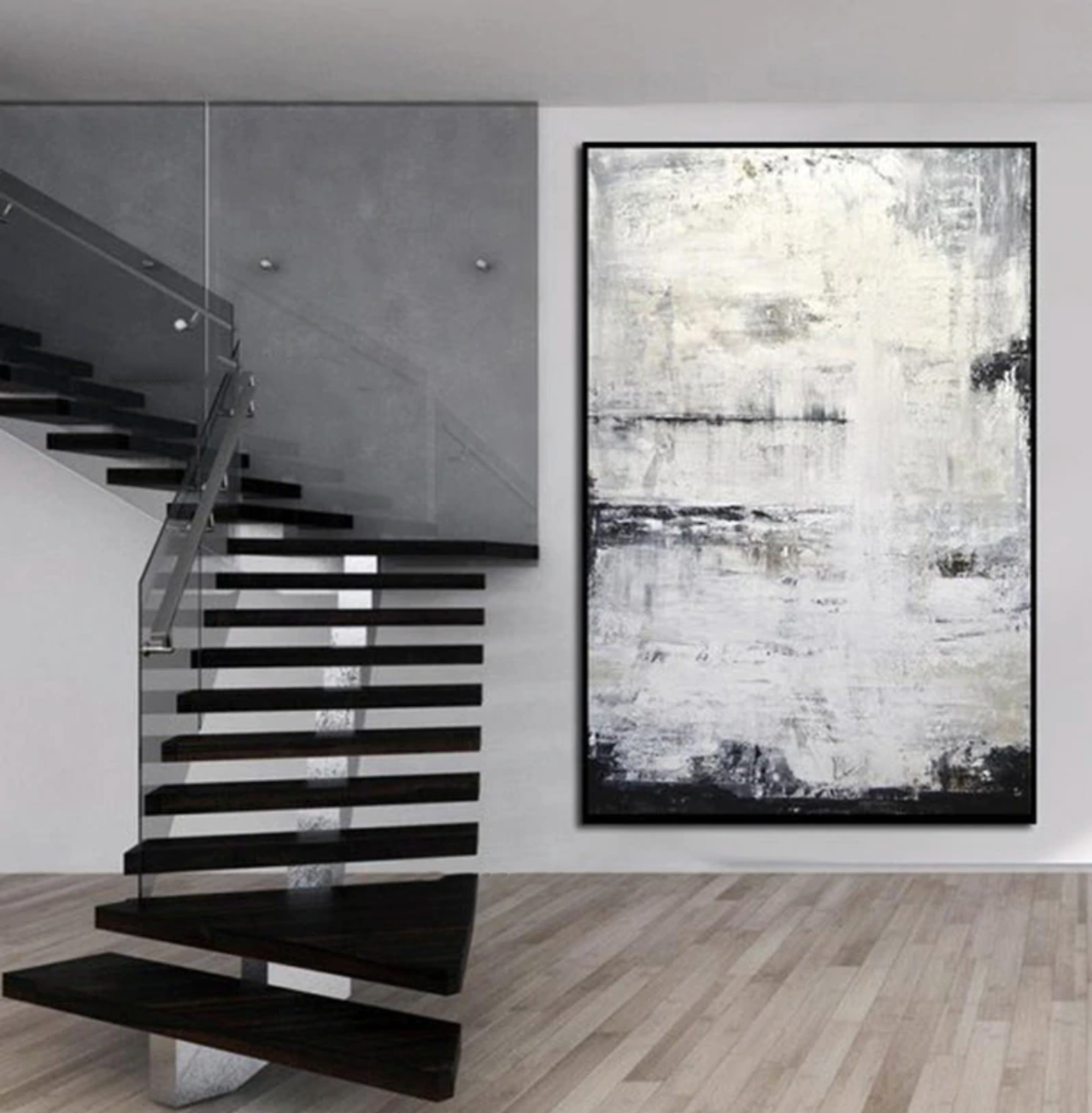 a staircase in a modern home with a painting on the wall