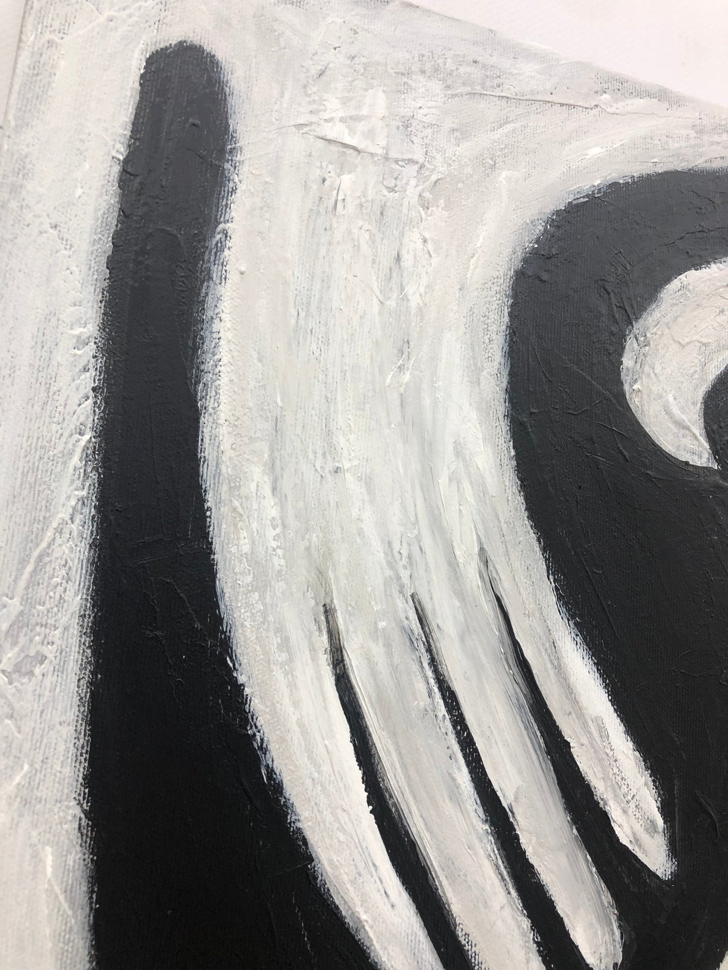 a black and white painting with white swirls