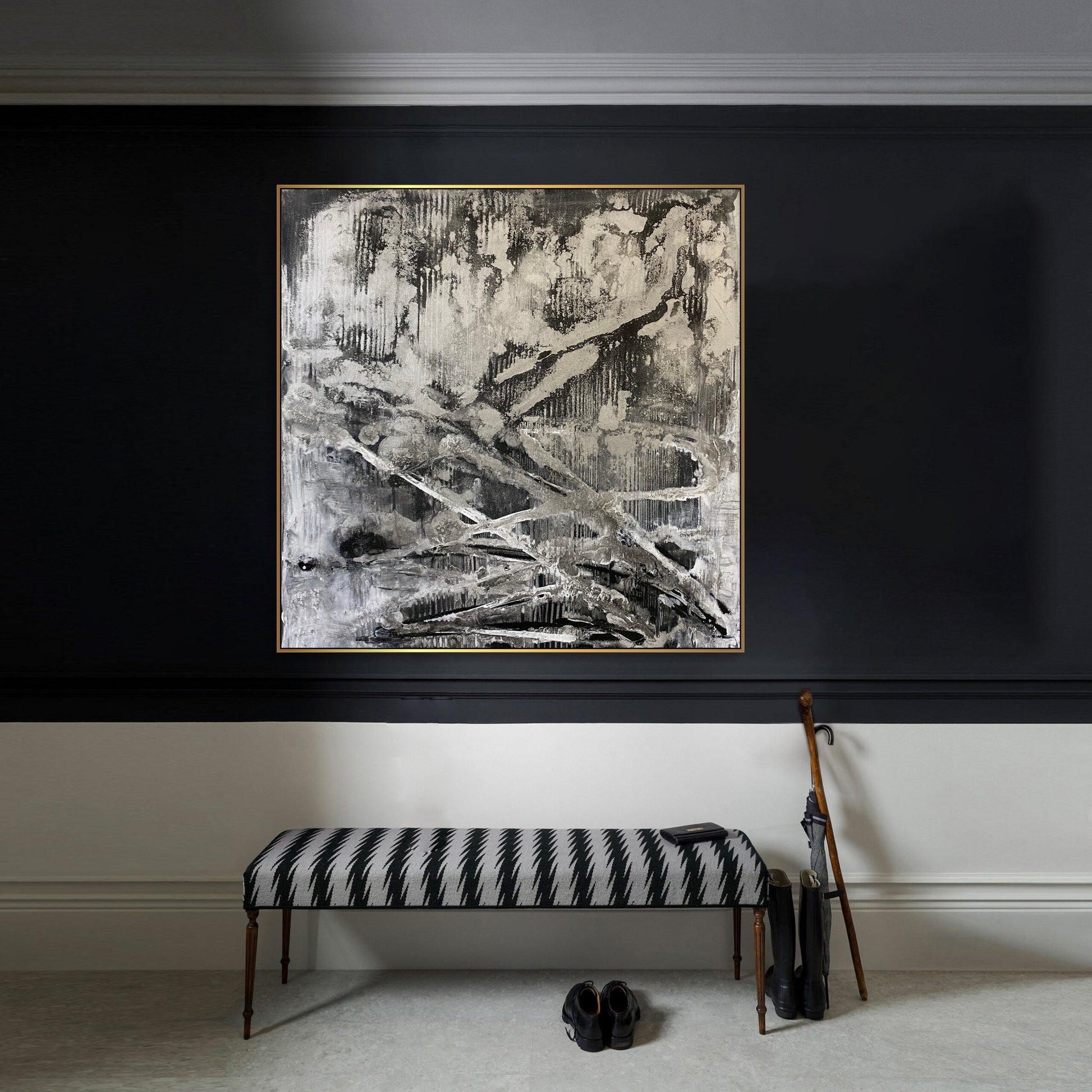 a black and white painting hanging on a wall