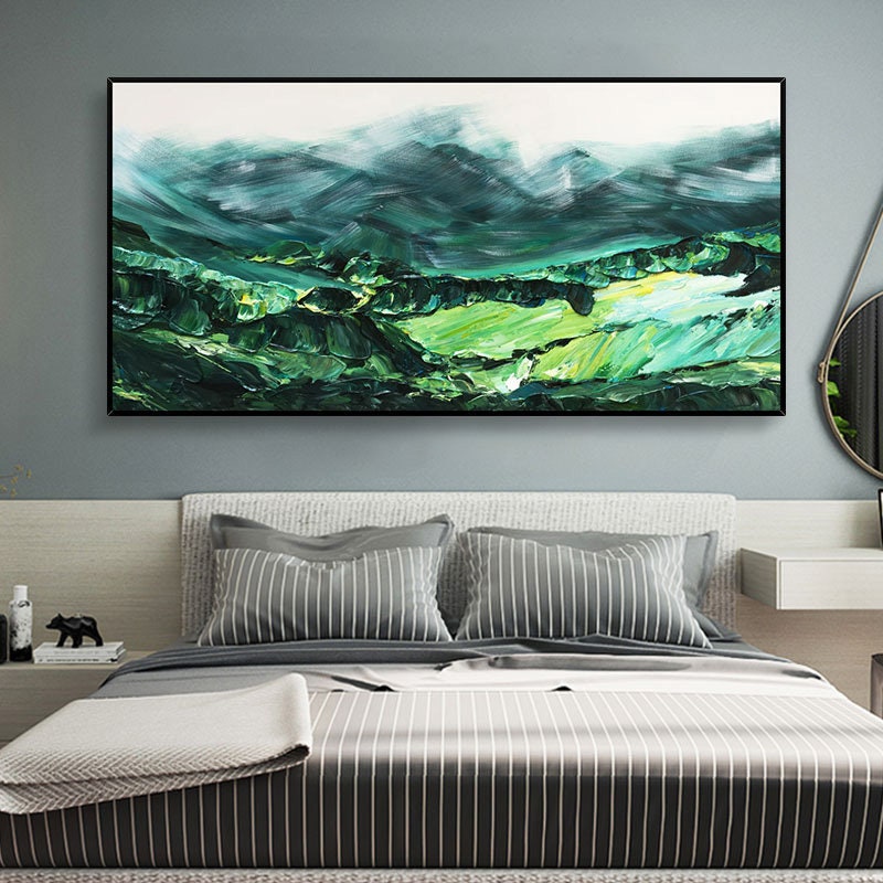 a bedroom with a large painting on the wall