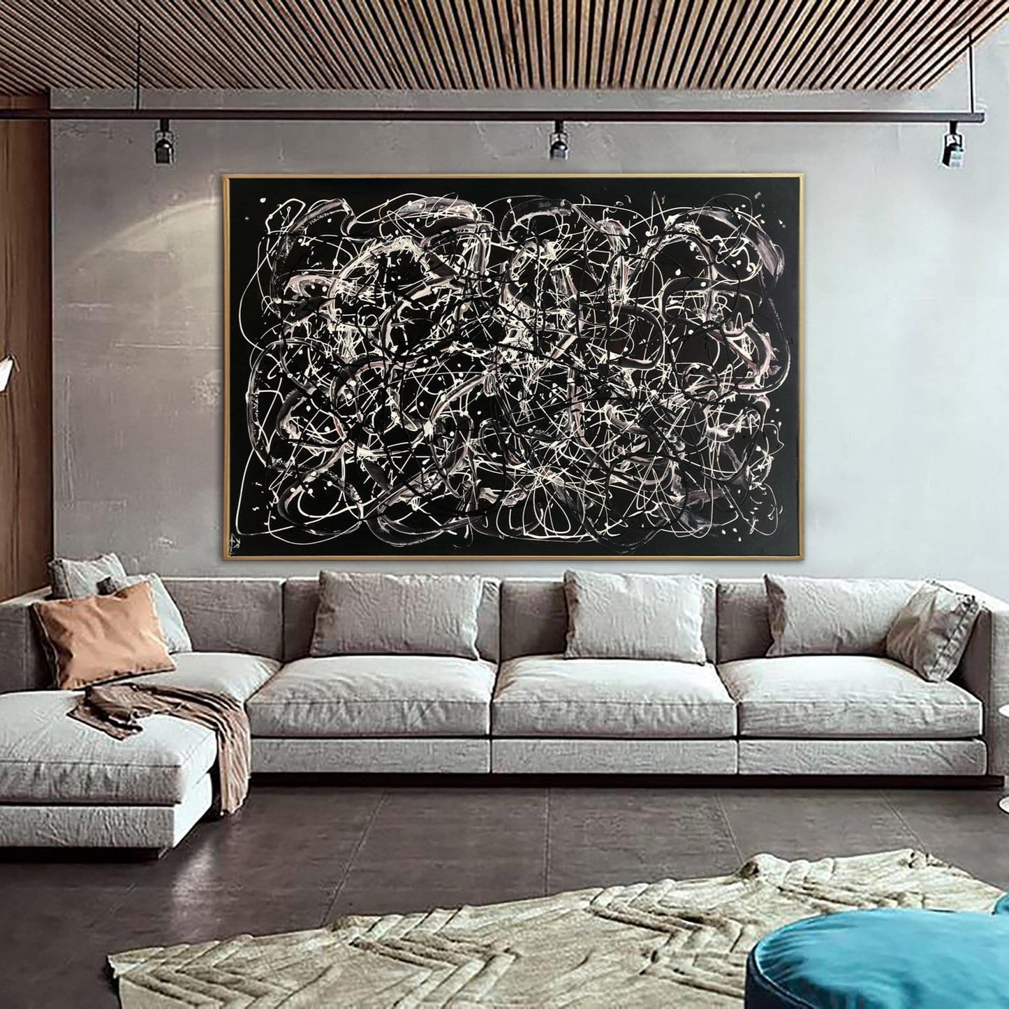 a modern living room with a large abstract painting hanging on the wall above a gray sectional sofa.
