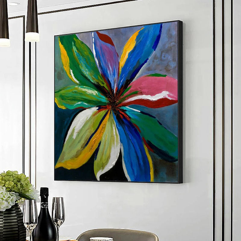 a painting hanging on a wall above a dining room table