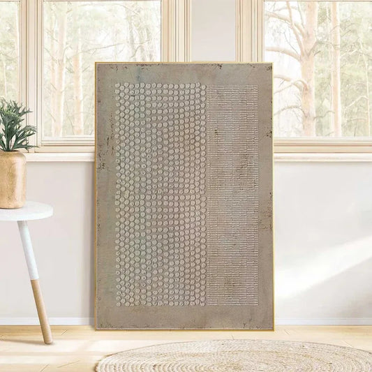 a large abstract painting with a textured surface, displayed in a room with a window and a small table with a plant.