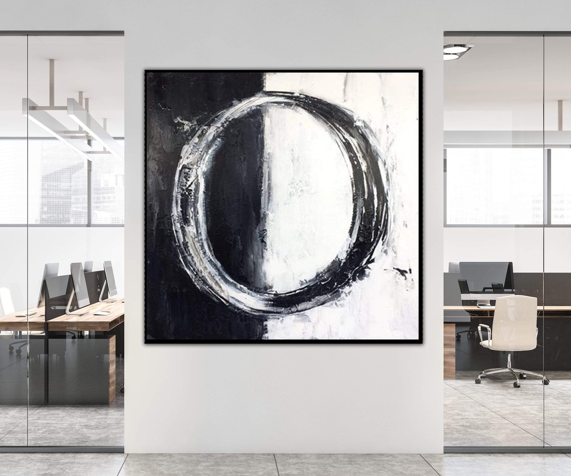 a black and white painting hanging on a wall