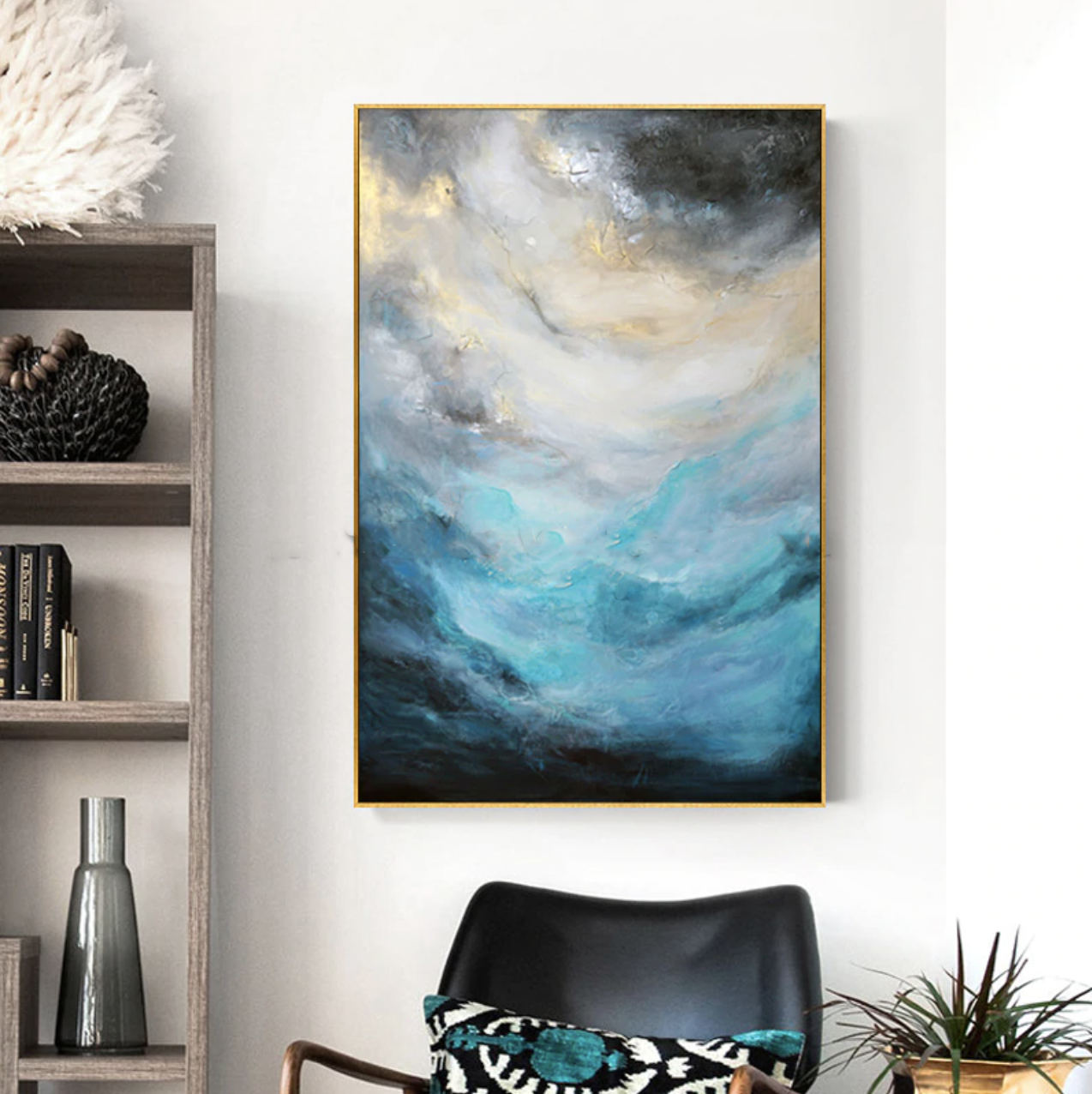 a painting hanging on a wall above a chair