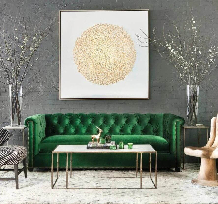 a living room with a green couch and two chairs