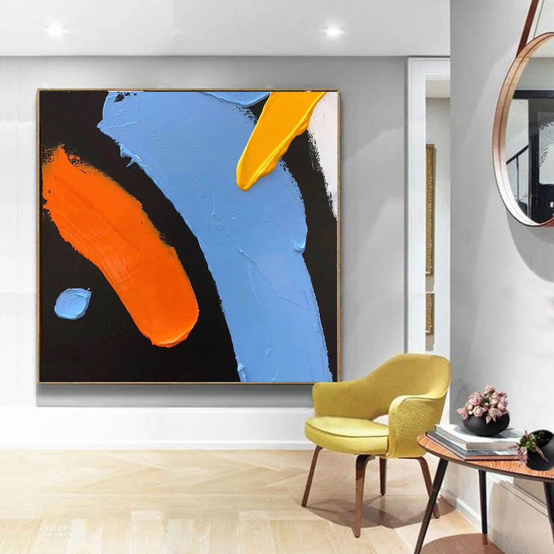 a living room with a painting on the wall