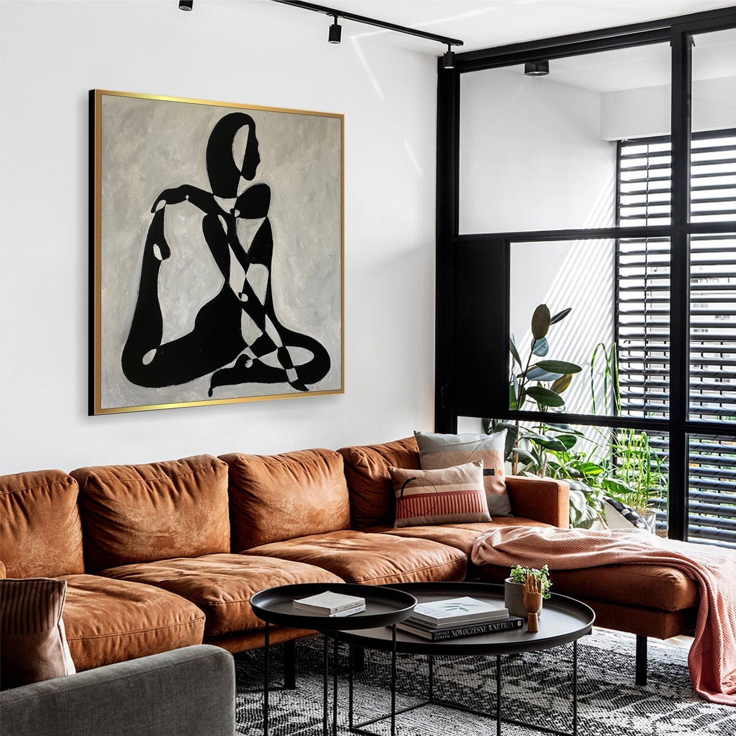 a living room filled with furniture and a painting on the wall