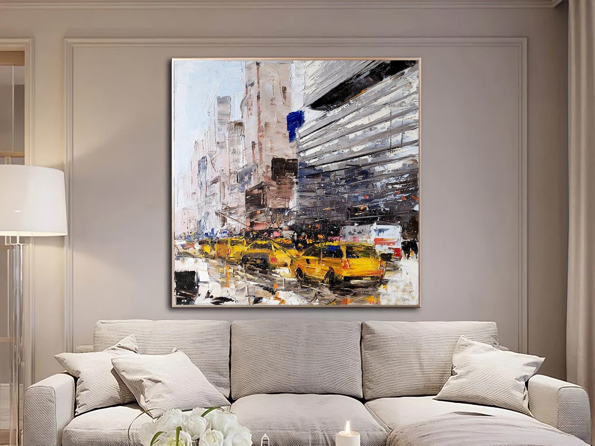 a living room with a couch and a painting on the wall