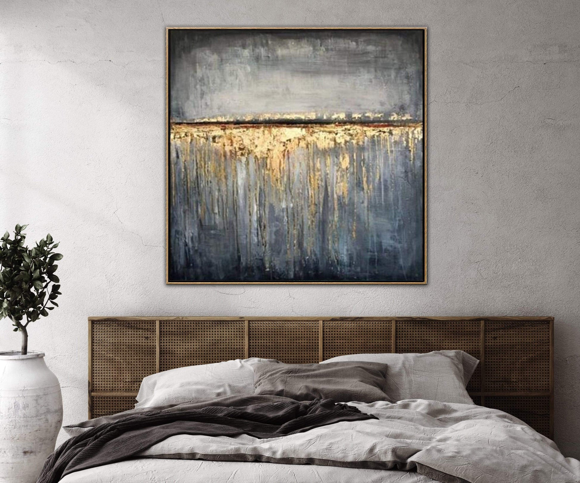 a painting hanging above a bed in a bedroom