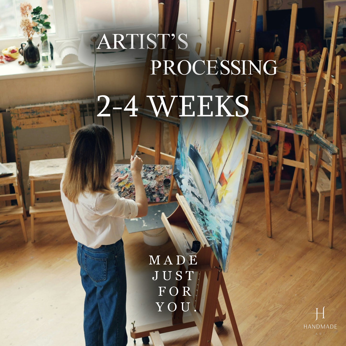 A woman is painting a picture in an art studio, with a large canvas and various art supplies visible.