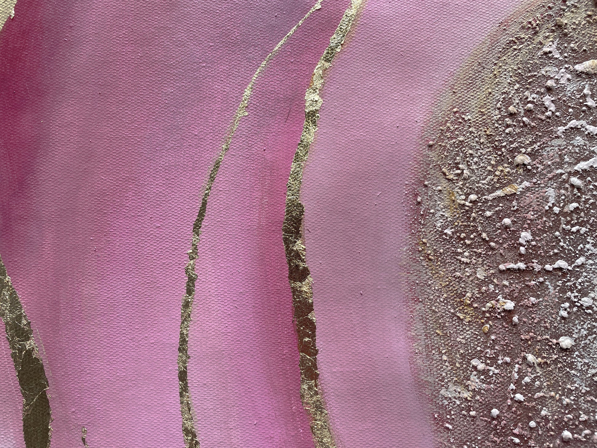 a close up of a painting with pink and gold paint