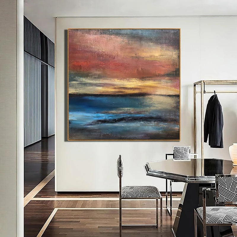 a painting hanging on a wall above a dining room table