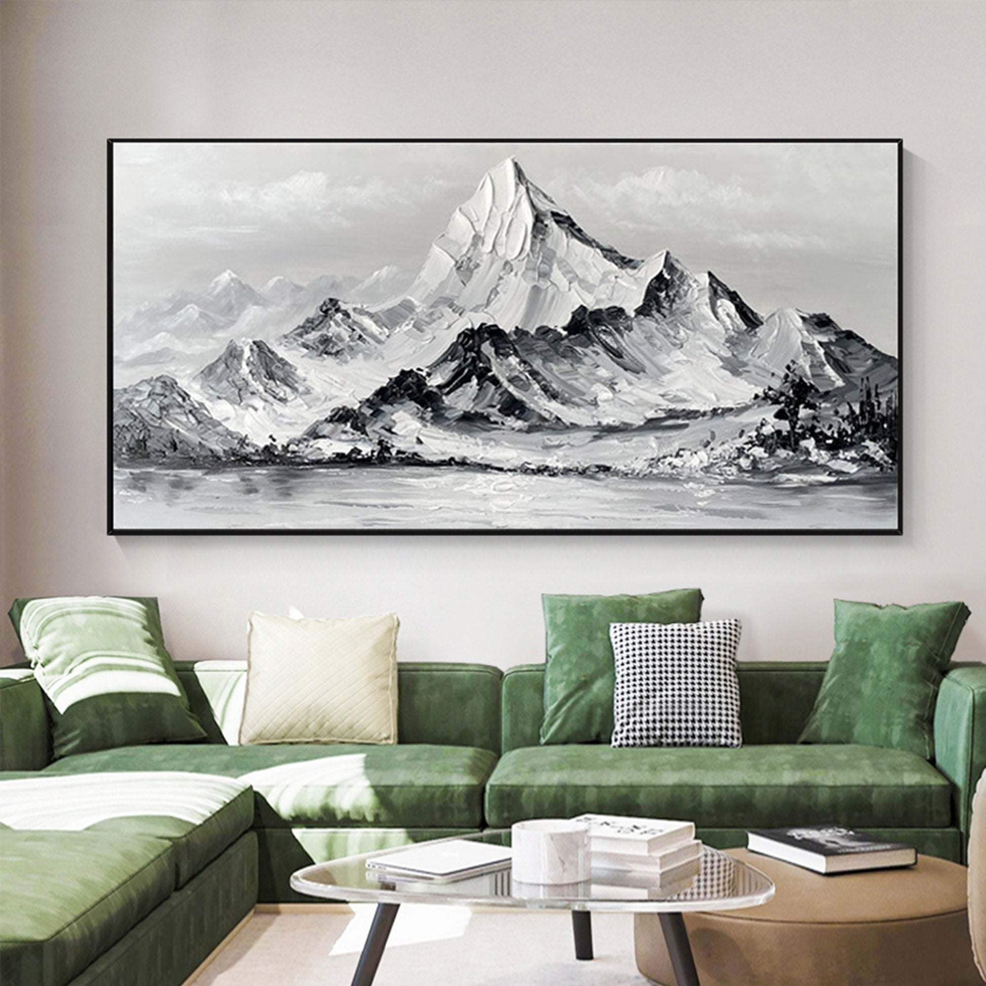 a living room with a green couch and a painting on the wall