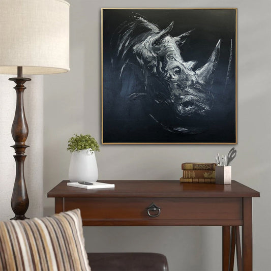 a picture of a rhino on a wall above a desk