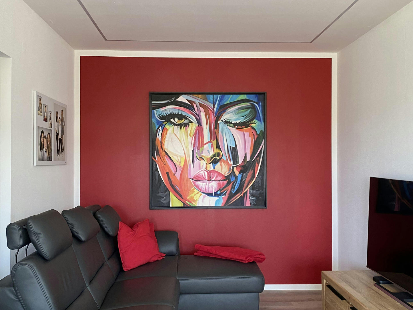 a living room with a couch and a painting on the wall