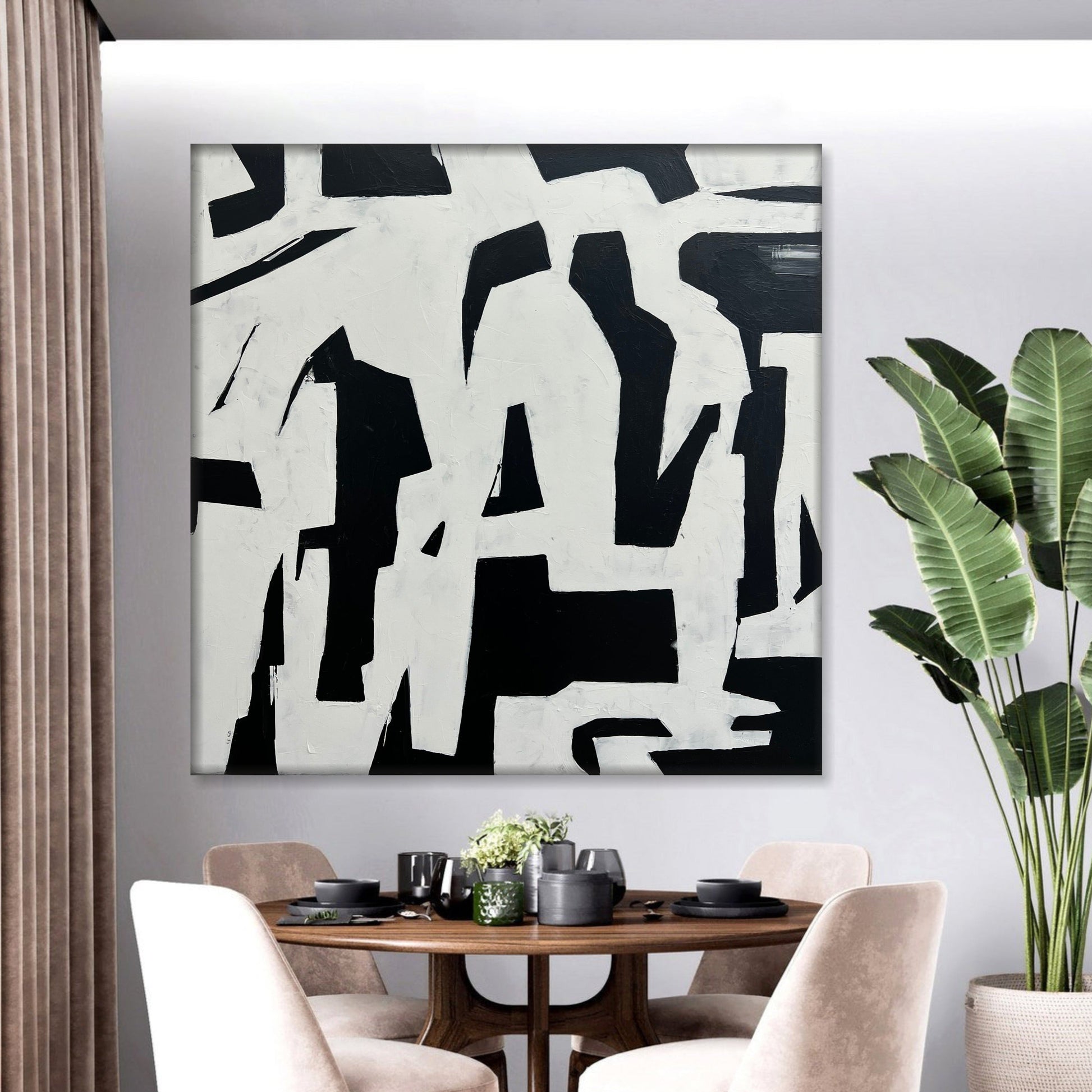 a dining room table with chairs and a painting on the wall