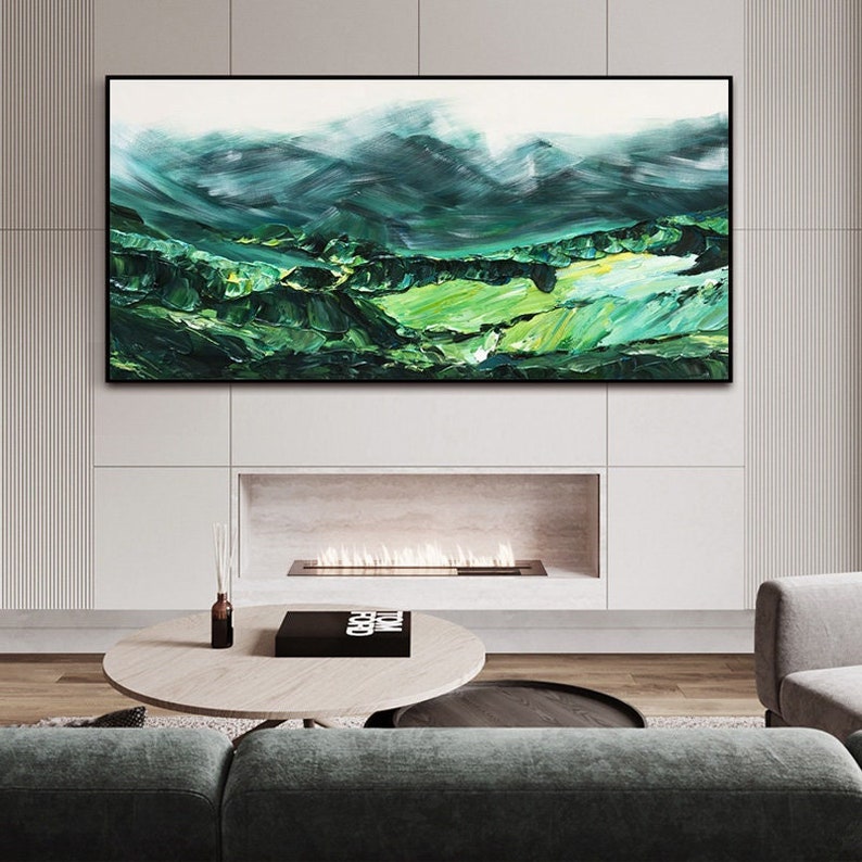 a living room with a large painting on the wall