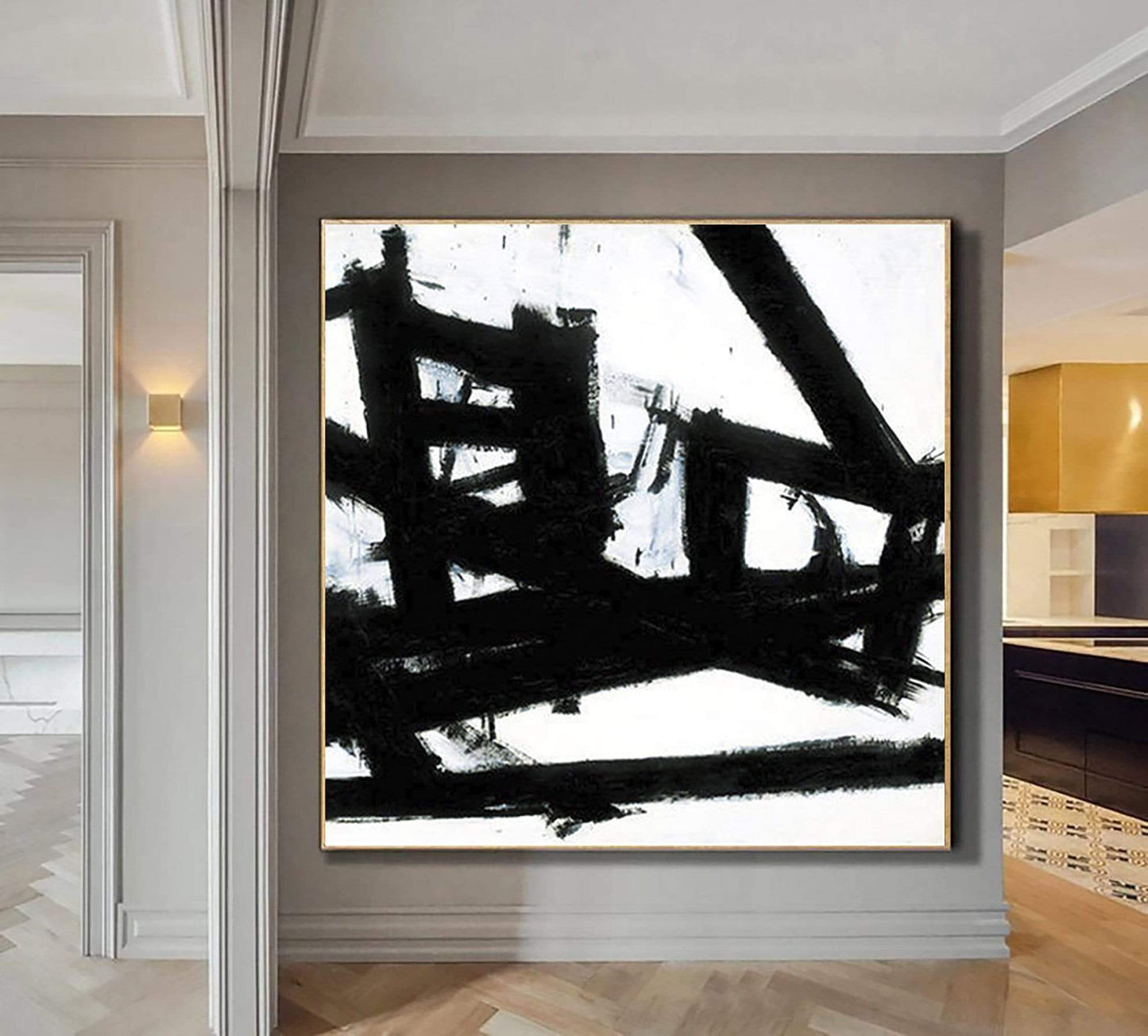 a black and white painting hanging on a wall