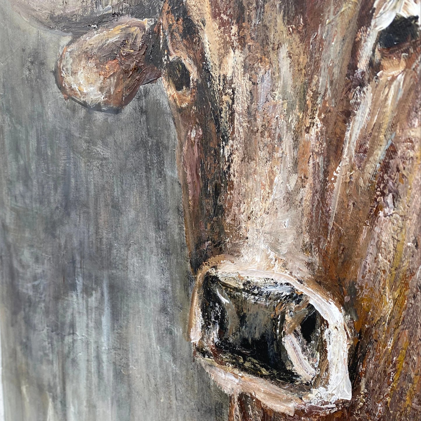 The image is a close-up of a painting depicting a large, detailed brown bull's head.