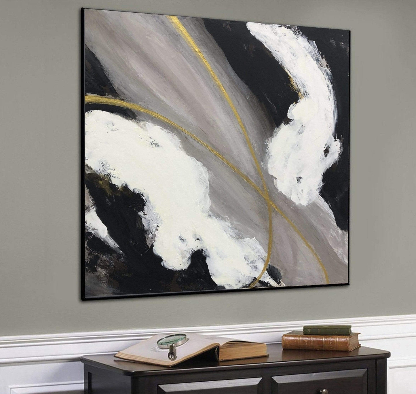 a black and white painting hanging on a wall