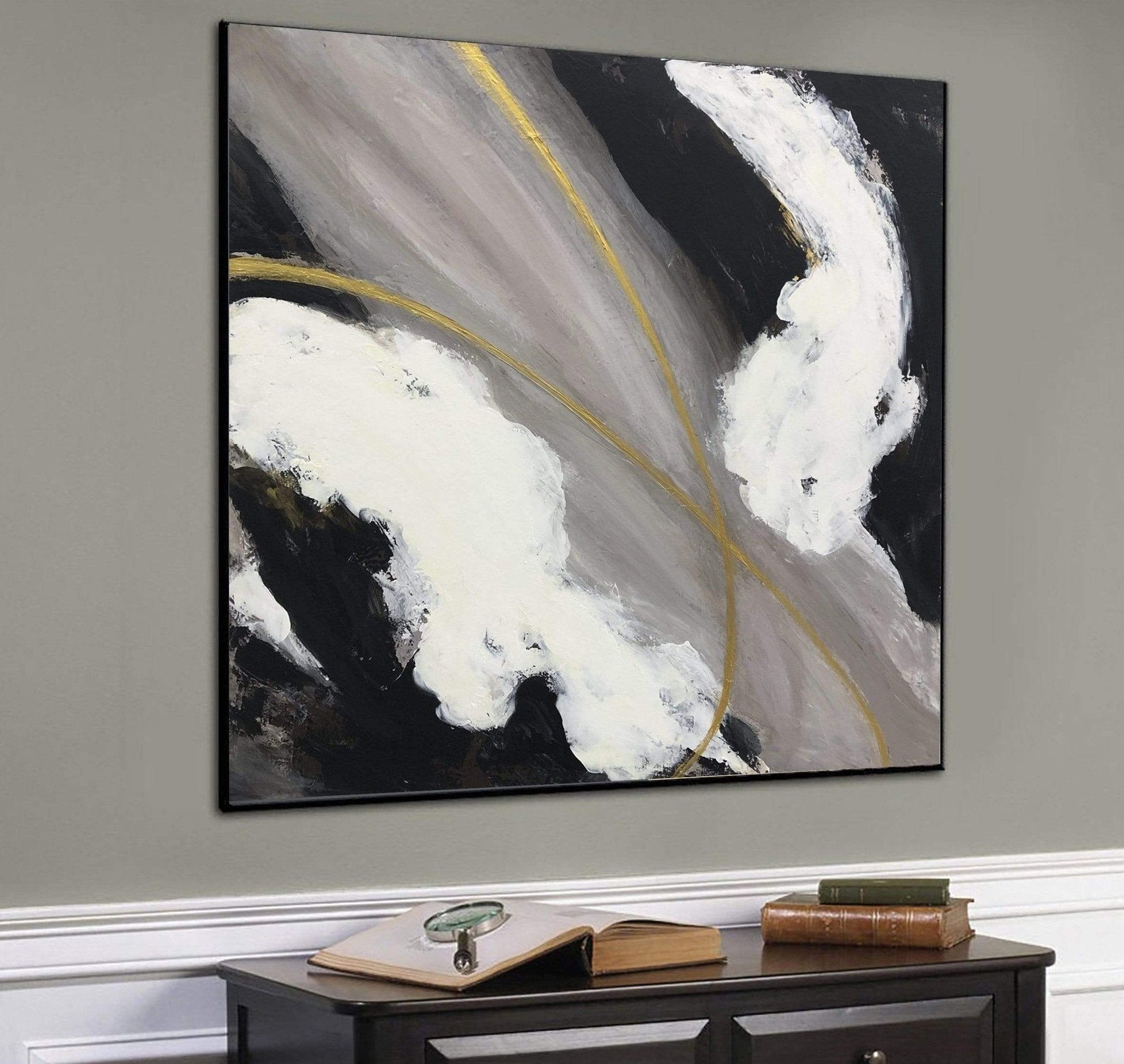 a black and white painting hanging on a wall