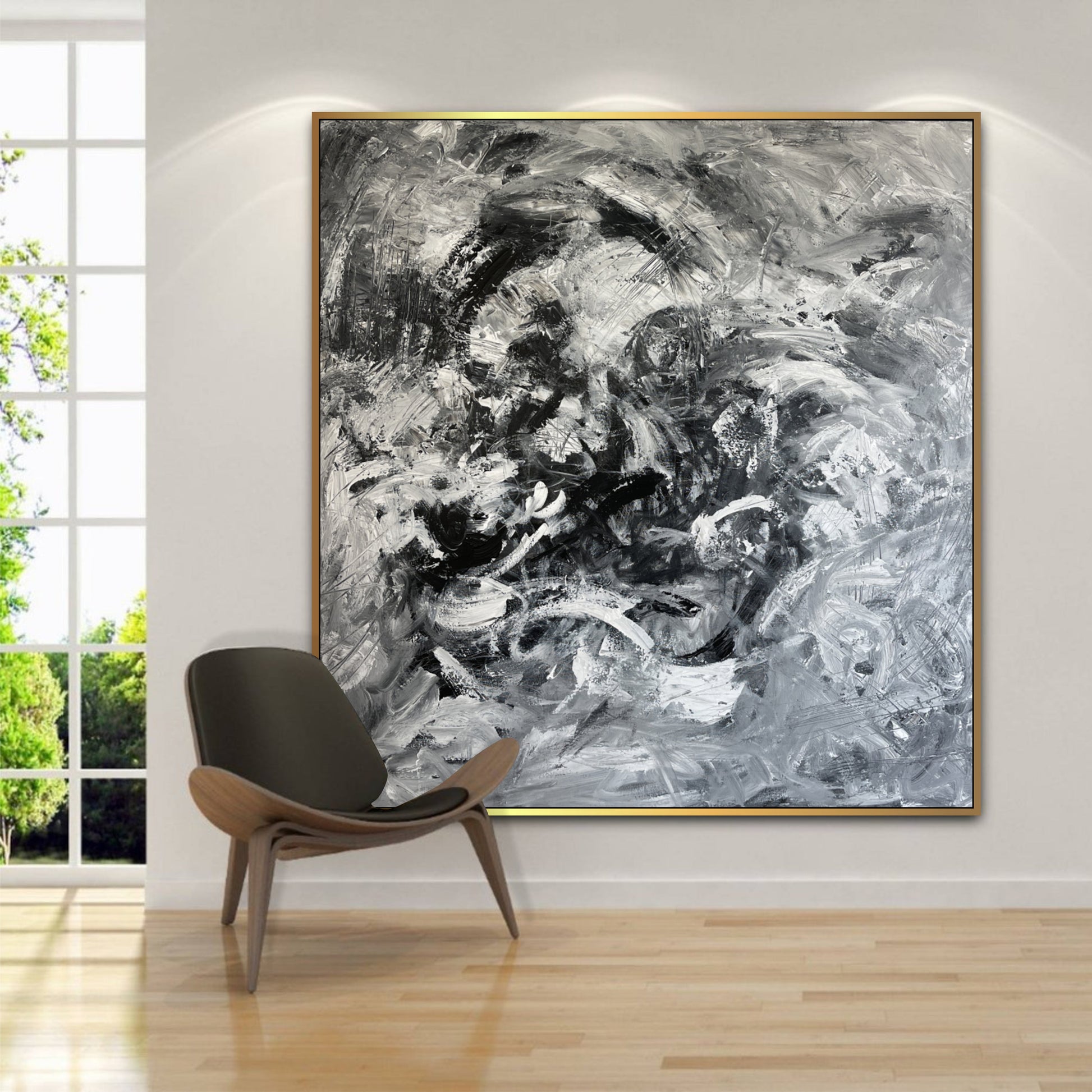 a large black and white painting hanging on a wall