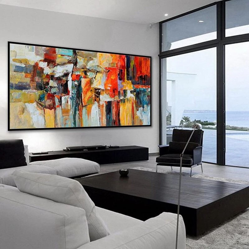 a living room with a large painting on the wall