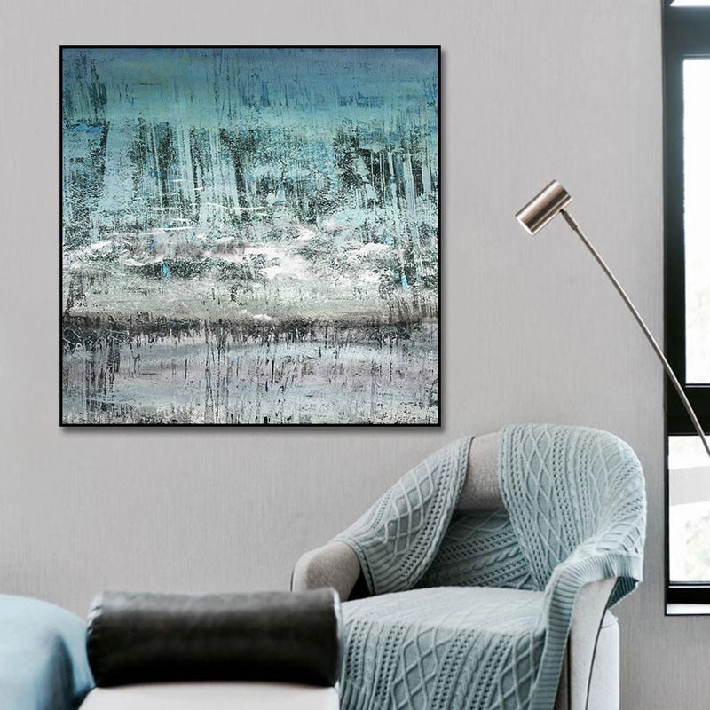 a living room with a chair and a painting on the wall