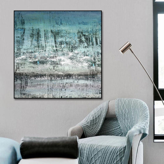 a living room with a chair and a painting on the wall