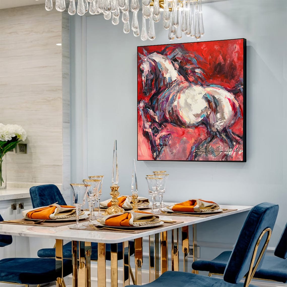 a dining room with blue chairs and a painting on the wall