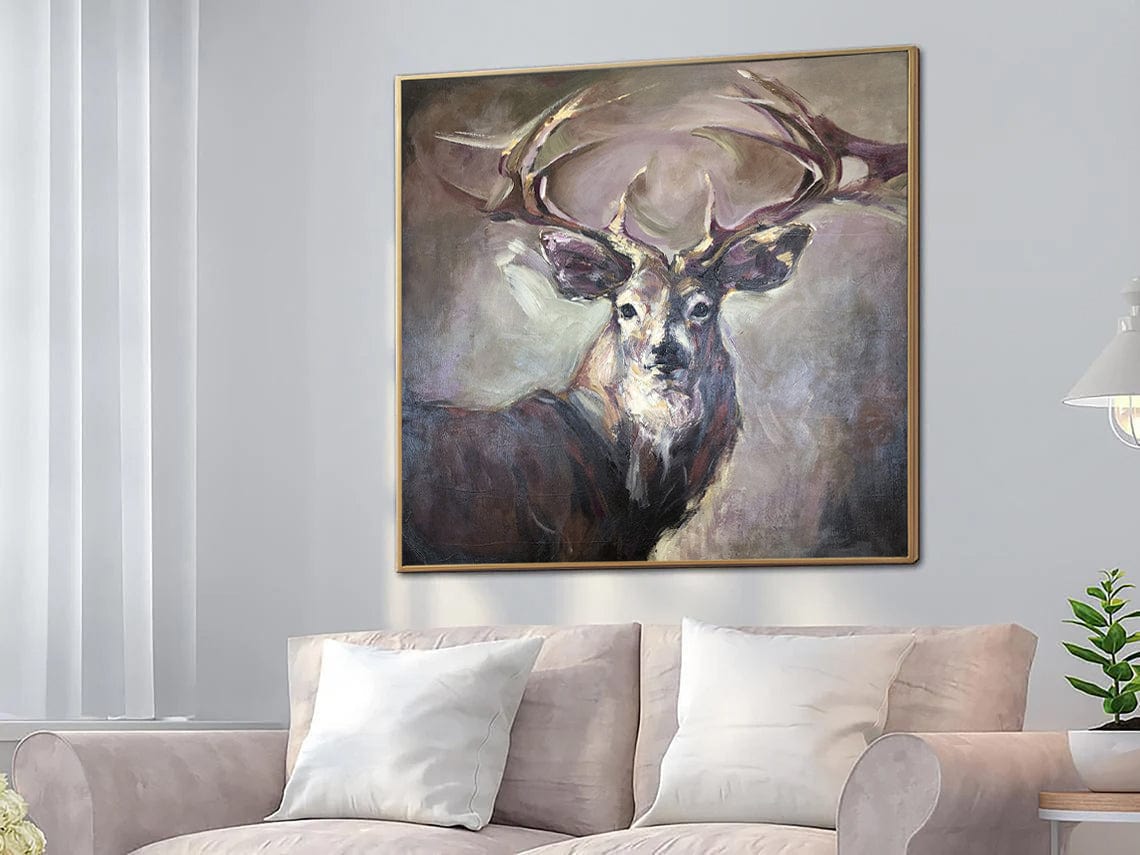 a living room with a couch and a painting of a deer